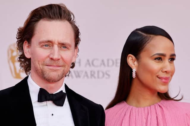 Tom Hiddleston and Zawe Ashton posing together on the red carpet upon arrival at the 2022 Baftas (Photo: TOLGA AKMEN/AFP via Getty Images)