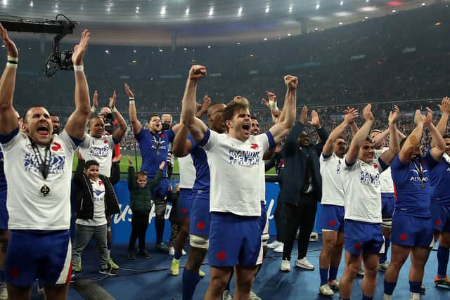 The France team celebrate after their Grand Slam victory during the Guinness Six Nations Rugby match between France and England at the Stade de France