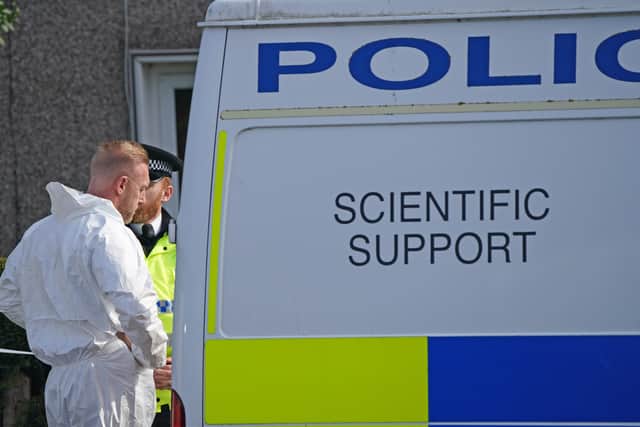 Police and forensic investigators outside the house in St Helens (Photo: PA)
