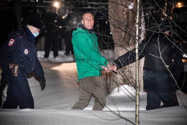 Opposition leader Alexei Navalny is escorted out of a police station on January 18, 2021, in Khimki, outside Moscow, following a court ruling that ordered him jailed for 30 days.