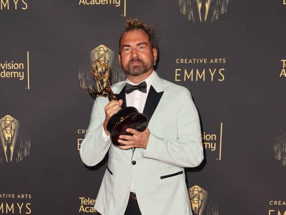 Marc Pilcher posing with his Emmy for his work on Bridgerton  (Photo by Kevin Winter/Getty Images)