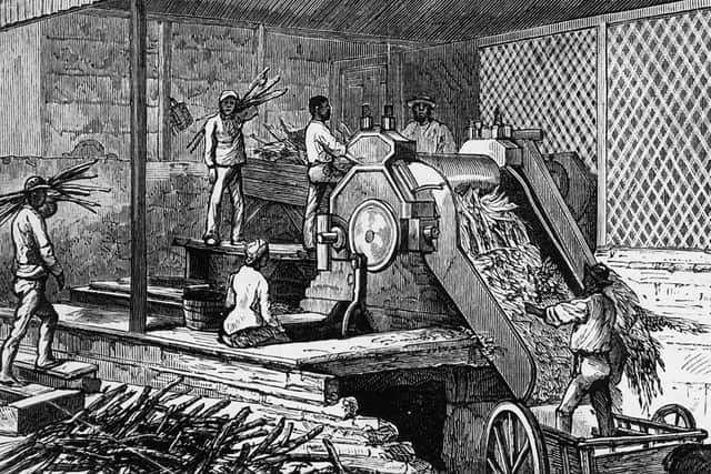 Workers operating a sugar cane crushing machine on a plantation in Jamaica, 1884 (Photo: Hulton Archive/Getty Images)