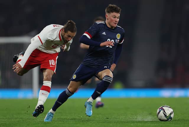 Nathan patterson of Scotland out paces Grzegorz Krychowiak of Poland during the international friendly match between Scotland and Poland at Hampden Park on March 24, 2022