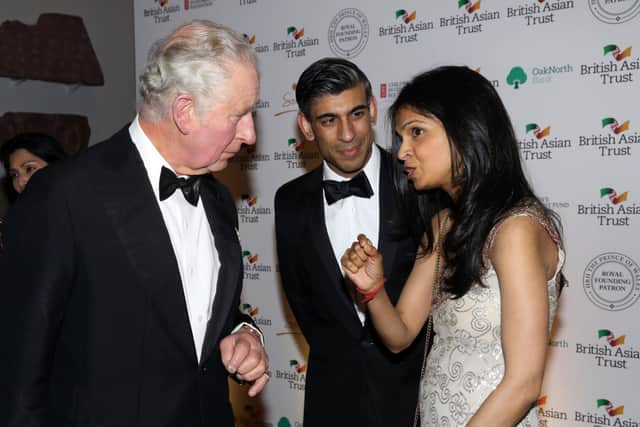 Akshata Murthy, seen here with her husband Rishi Sunak and Prince Charles, holds a fortune reported to be in the hundreds of millions (image: Getty Images)