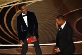 US actor Will Smith (R) approaches US actor Chris Rock onstage during the 94th Oscars at the Dolby Theatre in Hollywood, California on March 27, 2022. (Photo by Robyn Beck / AFP) 