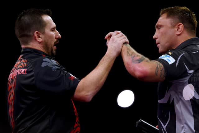 Jonny 'The Ferret' Clayton (L) of Wales celebrates winning after he competes against Gerwyn 'The Iceman' Price of Wales during Night 7 of Cazoo Premier League Darts on at Rotterdam Ahoy on March 24, 2022 in Rotterdam