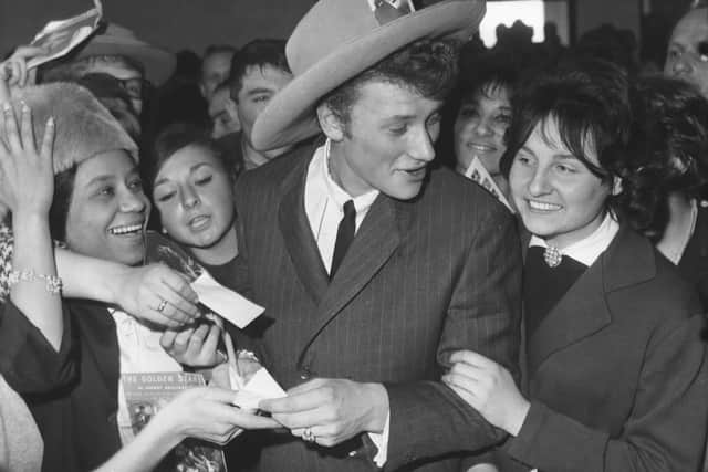 Johnny Hallyday surrounded by fans at Orly Airport in Paris in 1962 (Photo by Keystone/Hulton Archive/Getty Images)