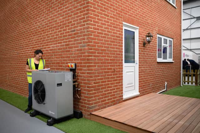 Air source heat pumps look like air conditioning units and are attached to the outside of the home (image: Getty Images)