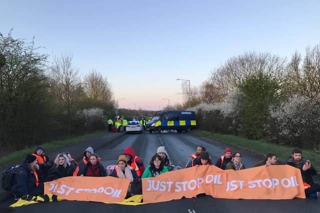 Protesters block the road in Kingsbury amid an anti-oil protest. (Credit: PA)