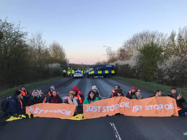 Protesters block the road in Kingsbury amid an anti-oil protest. (Credit: PA)
