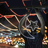 A shopkeeper in Jerusalem hangs a star and crescent - a symbol of Islam - ahead of Ramadan. (Credit: Getty Images)