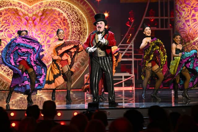 Clive Carter (C) performs on stage with the cast of Moulin Rouge (Photo: Jeff Spicer/Getty Images for SOLT)