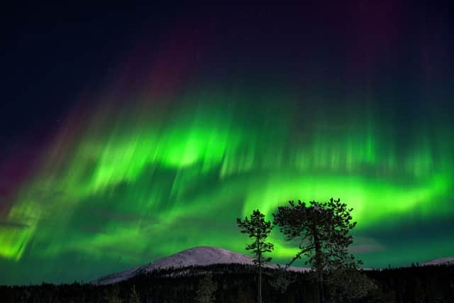 An aurora borealis illuminates the night sky above the Kellostapuli Fell in Kolari, Finnish Lapland (Photo: IRENE STACHON/Lehtikuva/AFP via Getty Images)