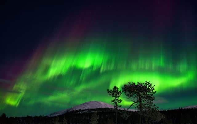 An aurora borealis illuminates the night sky above the Kellostapuli Fell in Kolari, Finnish Lapland (Photo: IRENE STACHON/Lehtikuva/AFP via Getty Images)