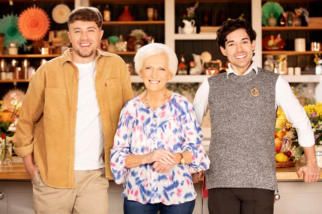 Roman Kemp, Mary Berry, and Tom Read Wilson smiling in the kitchen (Credit: BBC/Rumpus Media)