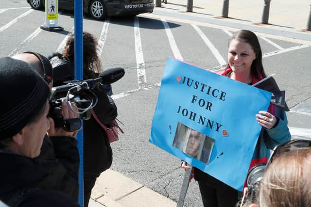 Spectators showing support for Johnny Depp and Amber Heard outside of Fairfax County Circuit Court on April 11, 2022 in Fairfax, Virginia. Depp is seeking $50 million in alleged damages to his career over an op-ed Heard wrote in the Washington Post in 2018. (Photo by Paul Morigi/Getty Images)