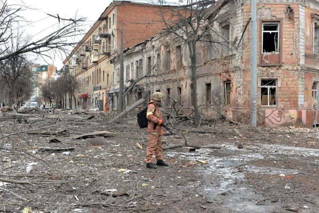 A member of the Ukrainian Territorial Defence Forces looks at destruction following a shelling in Ukraine’s second-biggest city of Kharkiv on 7 March (Photo: SERGEY BOBOK/AFP via Getty Images)
