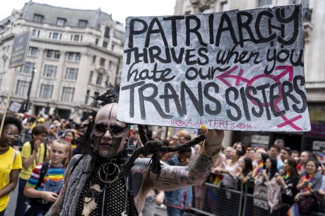 During the 2019 London Pride Parade, a participant holds up a sign which says ‘Patriarchy thrives when you hate our trans sisters’ (Photo: NIKLAS HALLE’N/AFP via Getty Images)