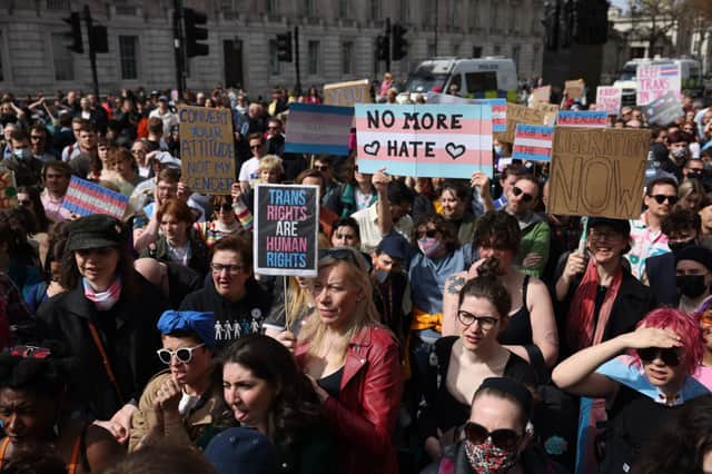 Demonstrators hold placards during the No Ban Without Trans protest opposite Downing Street on April 10, 2022 in London, England. LGBTQ+ collectives and supporters took to the streets to protest against the UK Government’s decision not to ban trans conversion therapies (Photo: Hollie Adams/Getty Images)