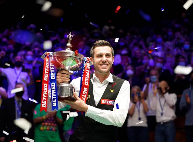<p>Mark Selby holds the World Championship Trophy in 2021. </p>