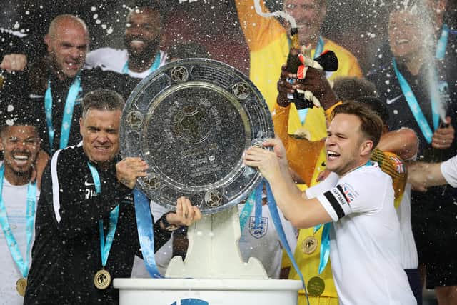 Robbie Williams, left, celebrates England win with Olly Murs in 2018