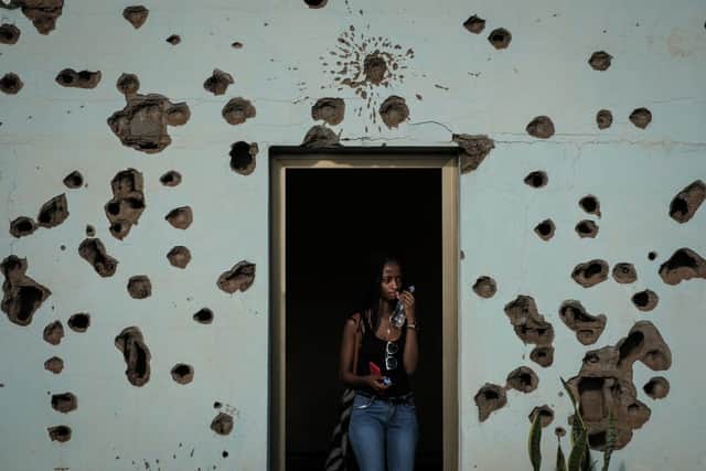 This picture taken in 2019 shows a tourist walking out of the room where  UN peacekeepers were killed during the Rwandan Genocide; Boris Johnson has said the country (Photo: YASUYOSHI CHIBA/AFP via Getty Images)