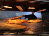 Fried haddock are served at a Fish and Chip Takeaway in Manchester (Photo credit should read PAUL ELLIS/AFP via Getty Images)