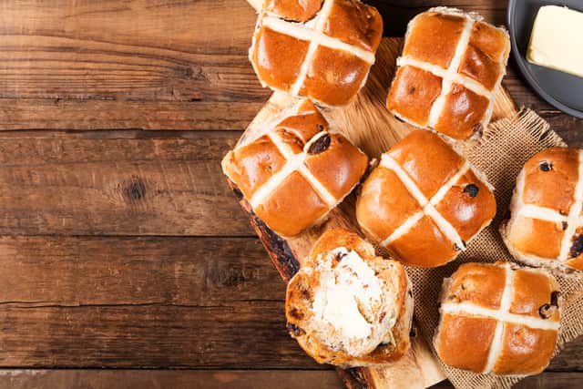 Hot cross buns are best served slathered in butter (image: Adobe)
