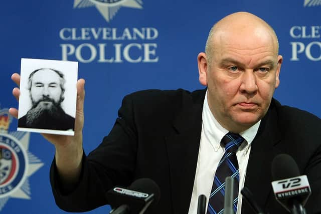 Detective Superintendent Tony Hutchinson of Cleveland Police holding the  fake passport picture of John Darwin (Photo: Christopher Furlong/Getty Images)