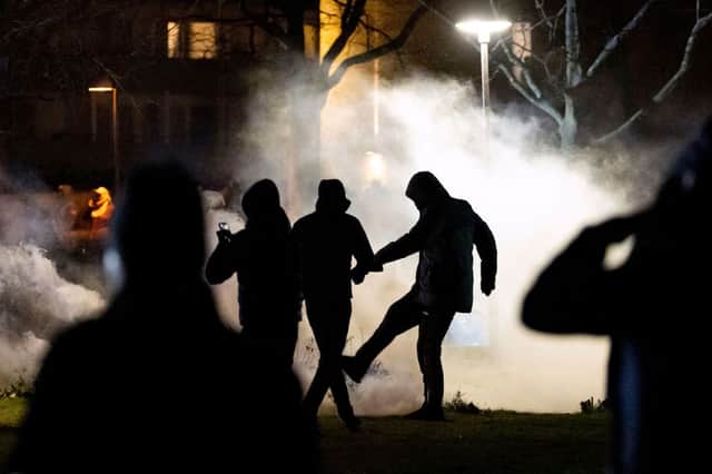 A protester kicks a tear gas canister at Rosengard in Malmo on April 17, 2022 (Photo: JOHAN NILSSON/TT NEWS AGENCY/AFP via Getty Images)