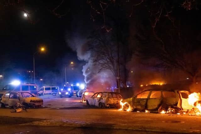 Burning cars are pictured on April 18, 2022 near Rosengard in Malmo (Photo: JOHAN NILSSON/TT NEWS AGENCY/AFP via Getty Images)
