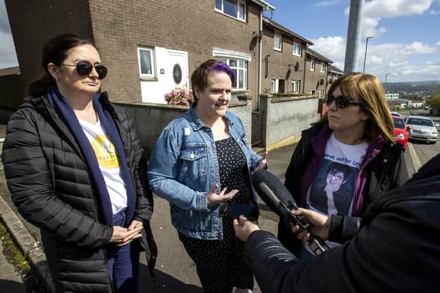 Lyra McKee's partner Sara Canning (centre) with Lyra's sisters Joan Hunter (left) and Nichola Corner during an interview after friends and family laid wreaths at the spot where Lyra McKee was shot three years ago on Fanad Drive in Derry