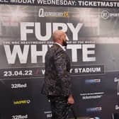 Tyson Fury looks at a picture of Dillian Whyte during a press conference. 