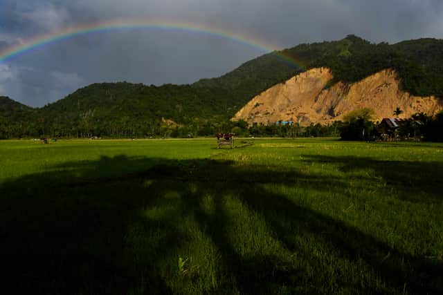 A rainbow is seen over an illegal sand quarry in Pekan Bada, Aceh province during Earth Day on April 22, 2021. (Photo by CHAIDEER MAHYUDDIN / AFP)