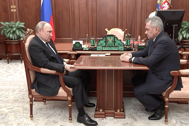 Putin was seen slouched in a chair and holding onto a table throughout a meeting with his defence minister.