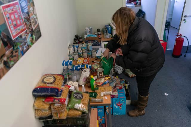 Val Reid, a volunteer with Community for Food, is seen unpacking donations from Morrisons supermarket at their centre on February 25, 2022 in Edinburgh, Scotland. 
