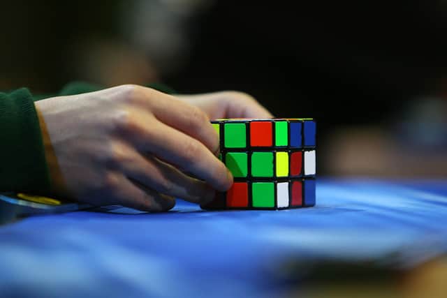 A competitor tries to solve the Rubik cube on the final day of the 2010 Rubik’s Cube German Championships in the 3x3x3 cube ‘Classical category’ in the western German city of Bottrop on September 12, 2010 (Photo: PATRIK STOLLARZ/AFP via Getty Images)