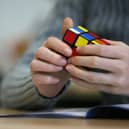 Have you successfully solved a rubik’s cube before? (Photo: PATRIK STOLLARZ/AFP via Getty Images)