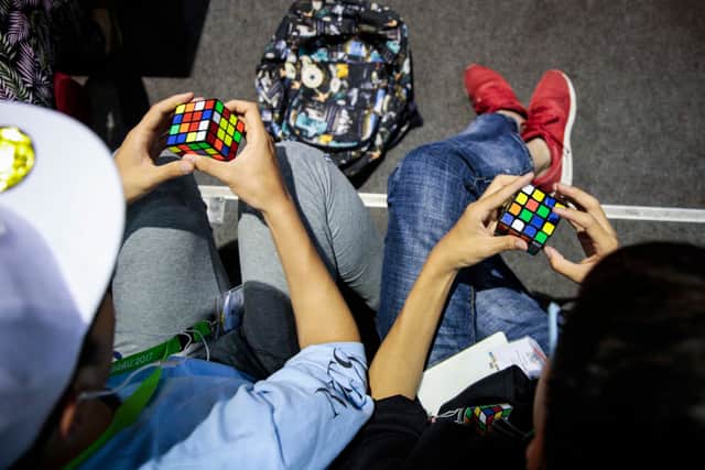 Competitors take part in the World Championship of Rubik’s cube in Saint Denis, on the outskirts of Paris, on July 16, 2017 (Photo: GEOFFROY VAN DER HASSELT/AFP via Getty Images)