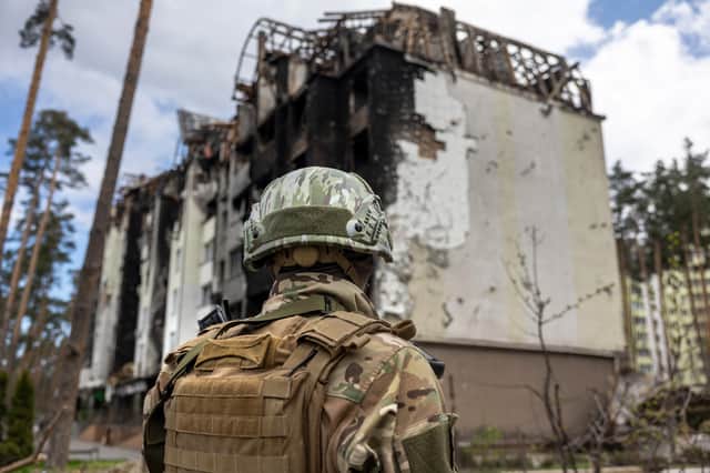 A Ukrainian army soldier stands guard at the war damaged Irpinsky Lipky residential complex following the visit of United Nations Secretary-General Antonio Guterres on April 28, 2022 in Irpin, Ukraine