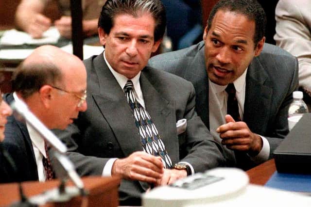 Defendant O.J. Simpson consulting with Robert Kardashian and Alvin Michelson during a hearing in Los Angeles, 3 May 1995 (Photo: VINCE BUCCI/AFP via Getty Images)