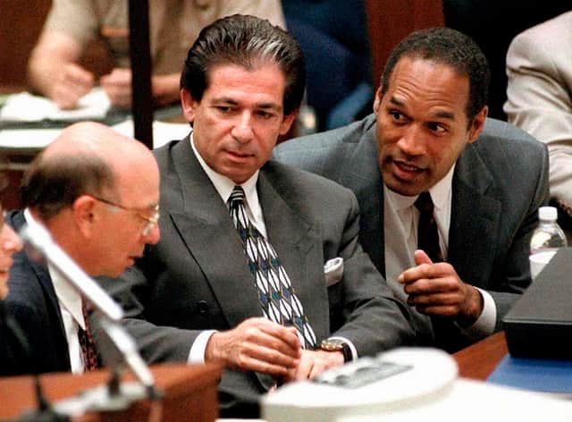 Defendant O.J. Simpson consulting with Robert Kardashian and Alvin Michelson during a hearing in Los Angeles, 3 May 1995 (Photo: VINCE BUCCI/AFP via Getty Images)