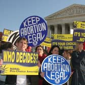 Pro-choice demonstrators wave signs in front of the US Supreme Court in 2005 (Photo: KAREN BLEIER/AFP via Getty Images)