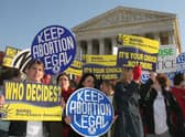 Pro-choice demonstrators wave signs in front of the US Supreme Court in 2005 (Photo: KAREN BLEIER/AFP via Getty Images)