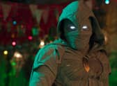 Oscar Isaac as Moon Knight, stood on a Cairo street on a dark night (Credit: Marvel Studios)