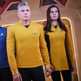 Ethan Peck as Mr Spock, wearing science division blue, and Anson Mount as Captain Pike and Rebecca Romijn as Number One, wearing command division gold, in Star Trek: Strange New Worlds (Credit: James Dimmock/Paramount+)