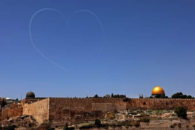 Smoke in the shape of a heart is released by Israeli Air Force planes performing above the Dome of the Rock mosque in Jerusalem during celebrations of Israel's 73rd Independence Day