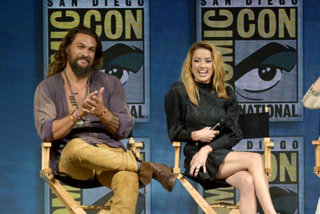 Jason Momoa and Amber Heard  speak onstage at the Warner Bros. Aquaman theatrical panel during Comic-Con International 2018 at San Diego Convention Center on July 21, 2018 in San Diego, California (Photo by Kevin Winter/Getty Images)