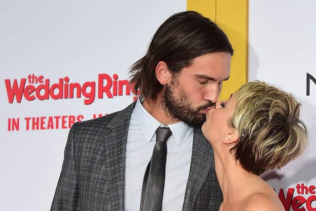 Actress Kaley Cuoco and husband Ryan Sweeting pose on arrival for the world premiere of the film ‘The Wedding Ringer’ in Hollywood, California on January 6, 2015 (Photo by FREDERIC J. BROWN/AFP via Getty Images)