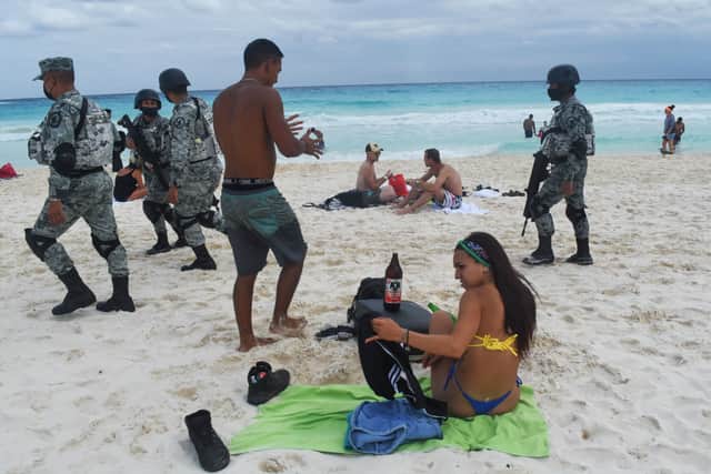 Members of the newly created Tourist Security Battalion of the National Guard patrol a beach in Cancun (Photo: AFP via Getty Images)